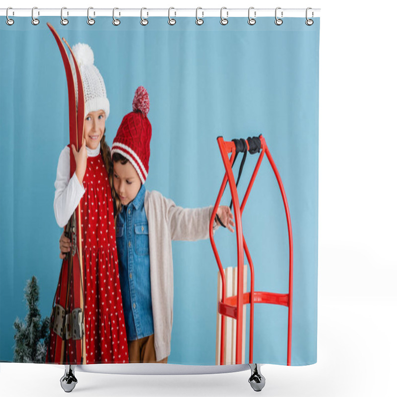 Personality  Girl In Winter Outfit Holding Skis And Hugging Brother Standing Near Sleight Isolated On Blue  Shower Curtains