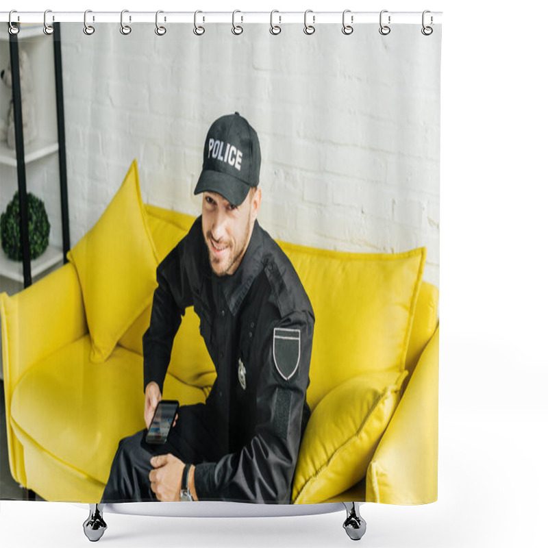 Personality  Happy Young Policeman With Smartphone Sitting On Yellow Couch And Looking At Camera Shower Curtains