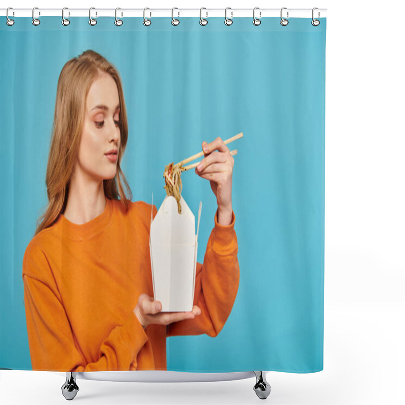 Personality  A Blonde Woman In An Orange Sweater Holds A White Container Filled With Noodles, Showcasing Asian Cuisine With Chopsticks. Shower Curtains