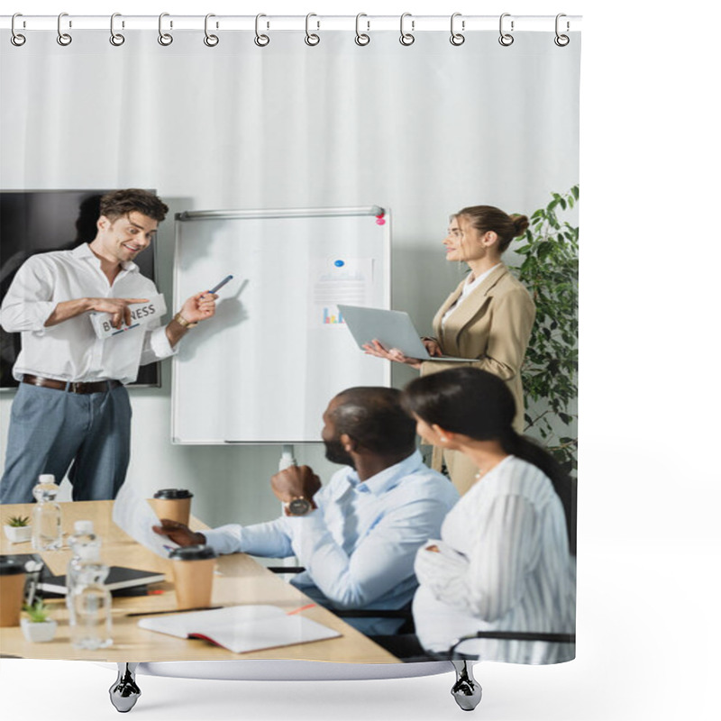 Personality  Smiling Businessman With Newspaper Pointing At Flip Chart Near Multiethnic Colleagues Shower Curtains