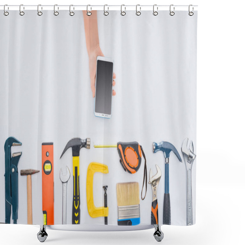 Personality  Cropped Shot Of Woman Using Smartphone With Various Tools Lying On White Shower Curtains