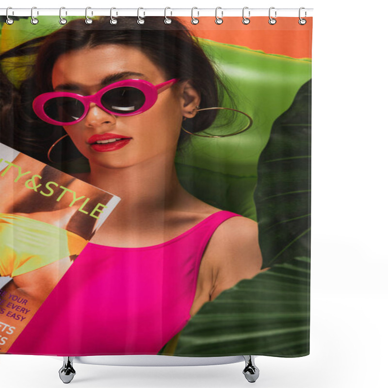 Personality  Top View Of Attractive Young Woman In Sunglasses And Swimsuit Lying On Inflatable Mattress With Magazine Near Green Palm Leaves On Orange Shower Curtains