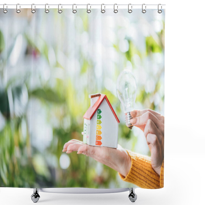 Personality  Cropped View Of Led Lamp And Carton House Model In Woman Hands, Energy Efficiency At Home Concept Shower Curtains