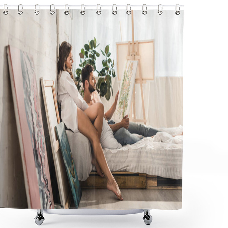 Personality  Side View Of Sexy Young Couple Looking At Painting While Man Lying In Bed And Girl Sitting Behind Guy Shower Curtains