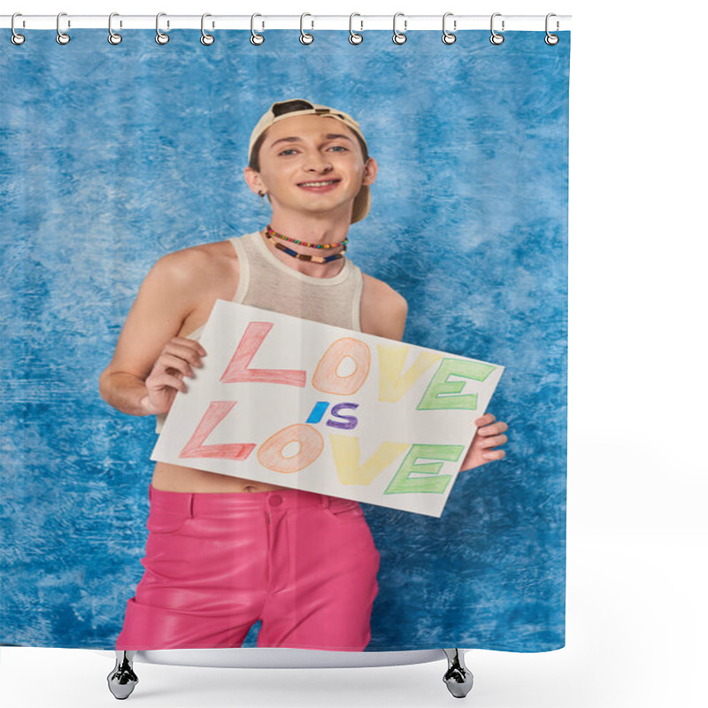 Personality  Cheerful Young Gay Activist In Baseball Cap And Pink Pants Smiling While Holding Placard With Love Is Love Words During Pride Month On Mottled Blue Background  Shower Curtains