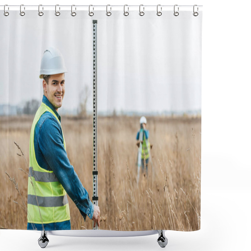 Personality  Selective Focus Of Smiling Surveyor With Ruler And Colleague With Digital Level In Field Shower Curtains