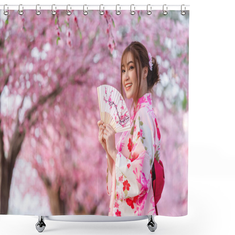 Personality  Woman In Yukata (kimono Dress) Holding Folding Fan And Looking Sakura Flower Or Cherry Blossom Blooming In The Garden Shower Curtains