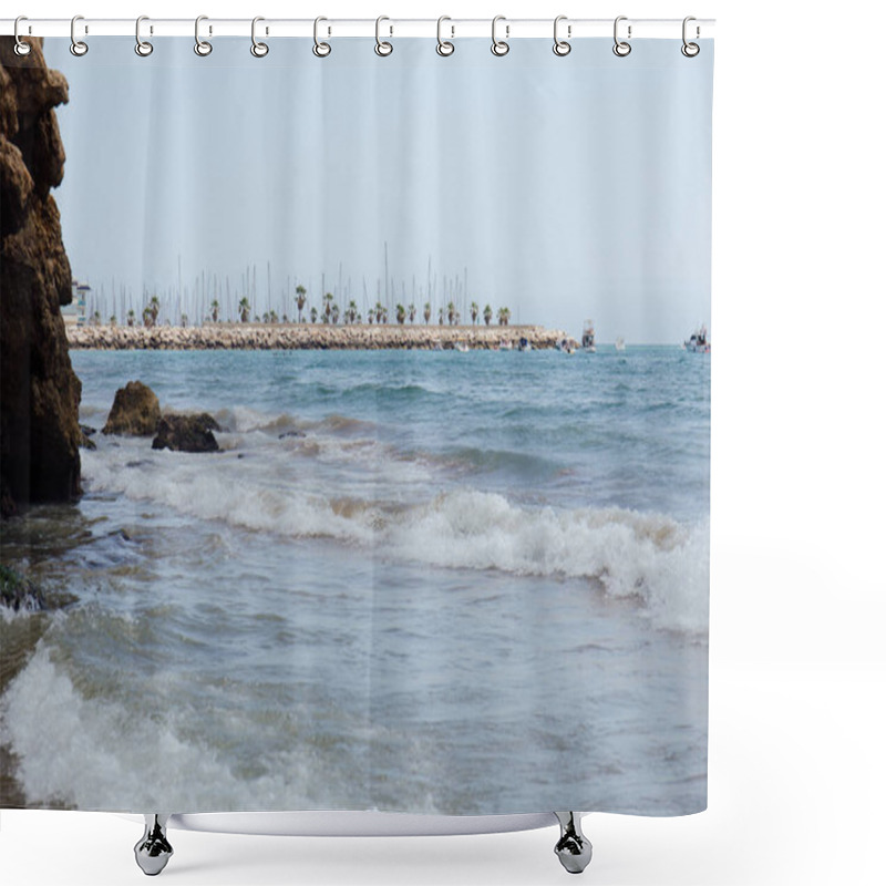 Personality  Stones And Sea Waves On Coast With Pier And Boats At Background In Catalonia, Spain  Shower Curtains