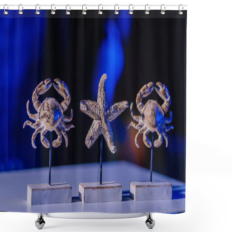 Personality  Close-up Of Decorative Sculptures Of Two Crabs And A Starfish Mounted On Stands, Set Against A Blue-lit Background With A Marine Theme. Shower Curtains