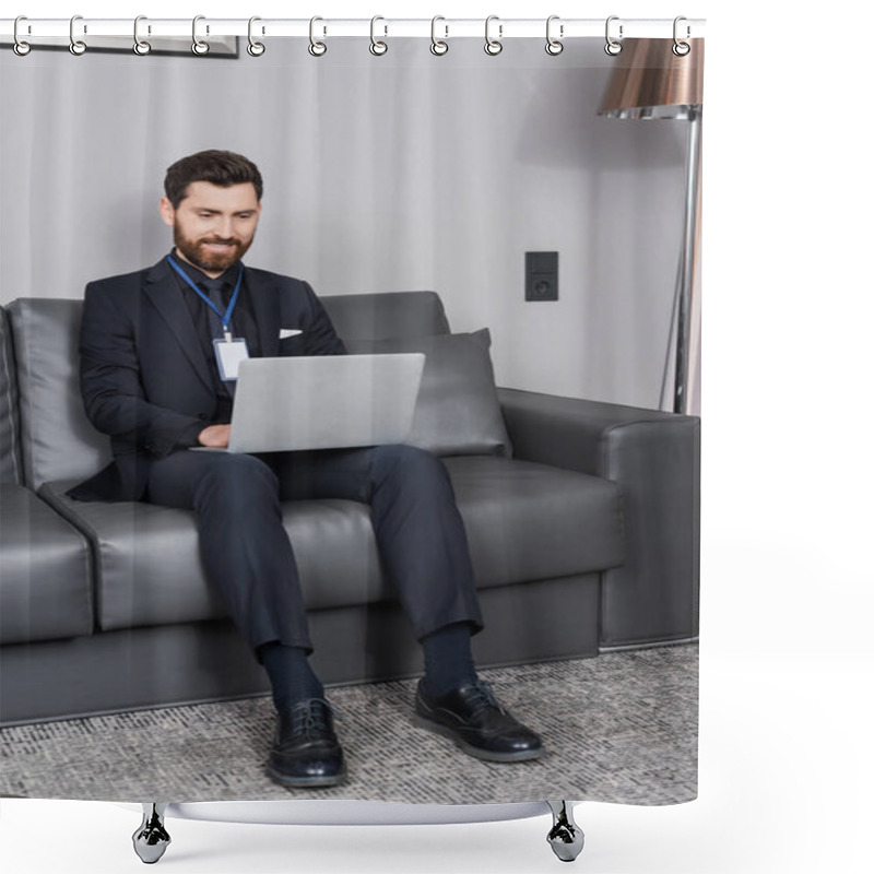 Personality  Cheerful Businessman With Id Badge Using Laptop While Sitting On Leather Couch In Hotel Room Shower Curtains