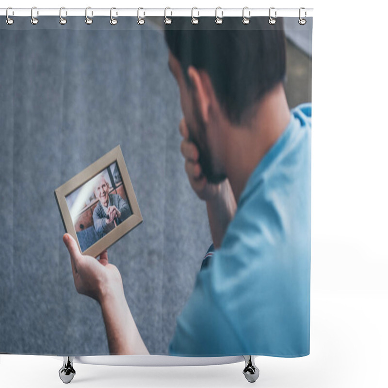 Personality  Back View Of Adult Man Grieving While Looking At Photo Frame With Old Man At Home Shower Curtains