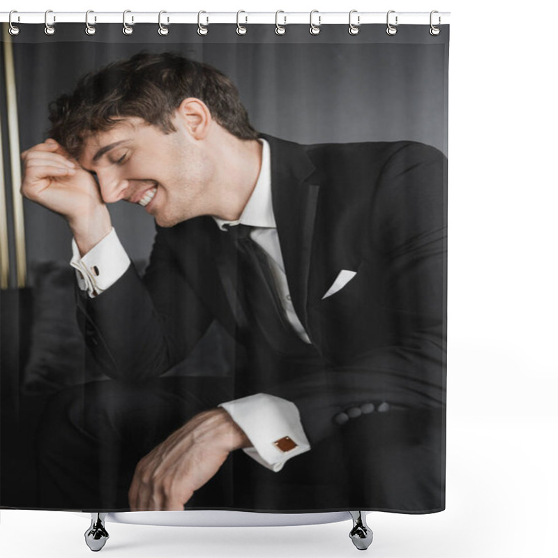 Personality  Portrait Of Joyful And Young Groom In Black Suit With White Shirt And Tie Touching Face With Hand While Smiling And Sitting On Comfortable Couch In Modern Hotel Room On Wedding Day Shower Curtains