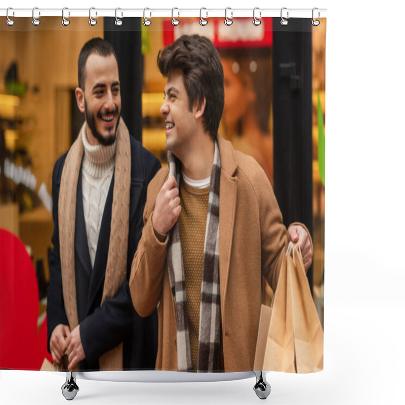 Personality  Smiling Gay Man Holding Shopping Bags And Adjusting Scarf Near Trendy Bearded Boyfriend And Blurred Showcase Shower Curtains