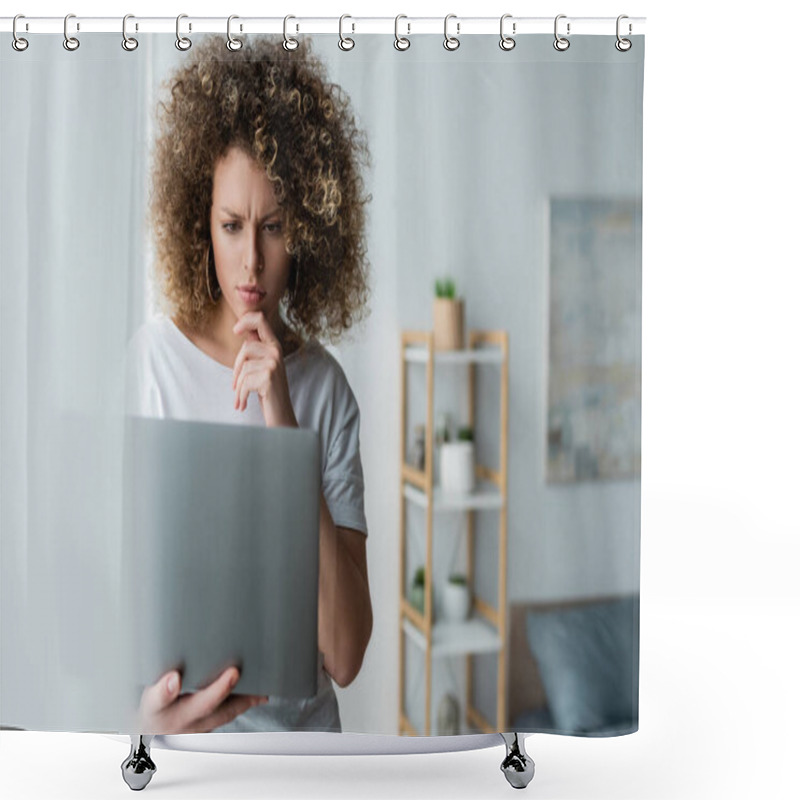 Personality  Thoughtful Woman Holding Hand Near Chin While Standing With Laptop On Blurred Foreground Shower Curtains