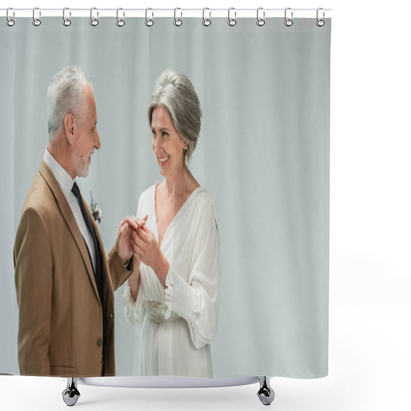 Personality  Happy Mature Bride In White Dress Wearing Engagement Ring On Finger Of Middle Aged Groom Isolated On Grey Shower Curtains