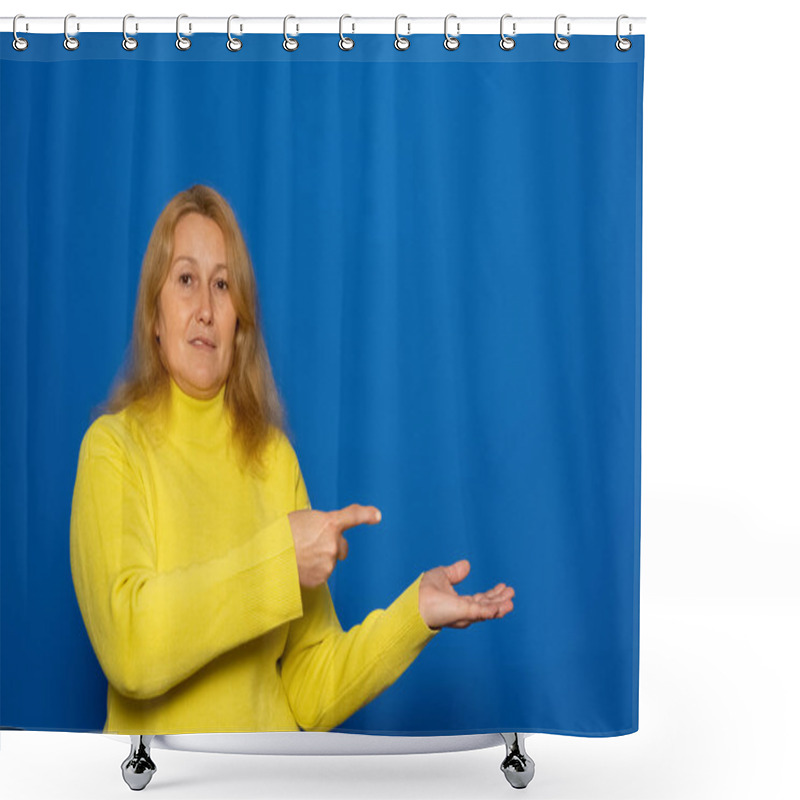 Personality  Caucasian Woman In Her 40s Wearing A Yellow Sweater Pointing With Her Finger At A Discounted Product Offer And Selecting A Product Isolated On A Blue Background Shower Curtains