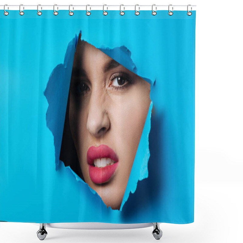 Personality  Angry Woman With Smoky Eyes And Pink Lips Looking At Camera Across Ripped Blue Paper Shower Curtains