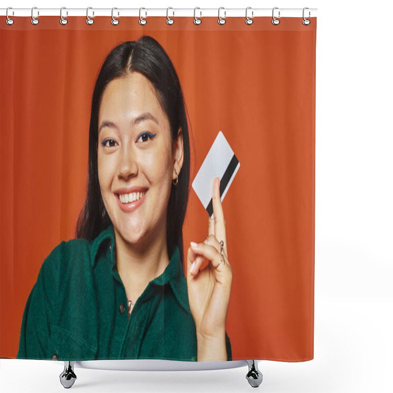 Personality  Happy Young Asian Woman In Green Jacket Holding Credit Card On Orange Background, Consumerism Shower Curtains