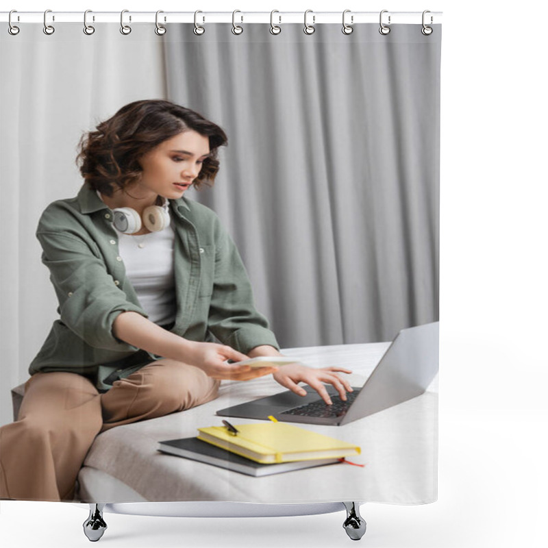 Personality  Digital Nomad Lifestyle, Young Attractive Woman With Wavy Brunette Hair, Wireless Headphones And Smartphone In Hand Typing On Laptop While Sitting On Bed Near Notebooks And Pen In Modern Hotel Room  Shower Curtains