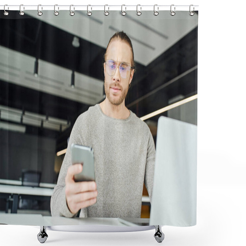 Personality  Entrepreneur In Eyeglasses And Casual Clothes, With Serious Face Expression, Looking At Mobile Phone While Working On Startup Project Near Laptop On Blurred Foreground In Modern Office Space Shower Curtains