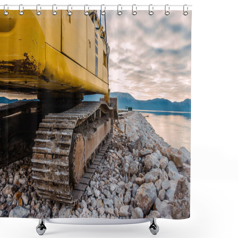 Personality  Side View Of A Yellow Excavator On Rocky Terrain Near Water With Mountains In The Background At Sunset Shower Curtains