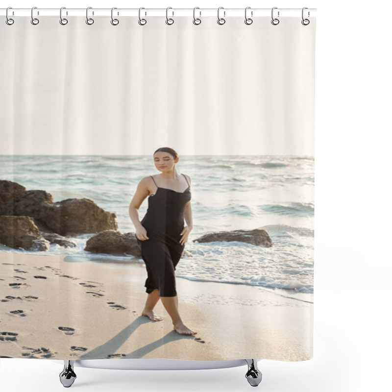 Personality  A Young Woman In A Black Sundress Walks Barefoot On A Sandy Beach, Leaving Footprints Behind. The Ocean Waves Lap At The Shore Behind Her. Shower Curtains