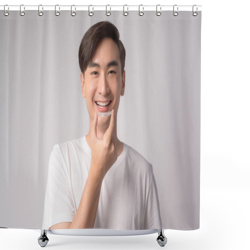 Personality  A Young Smiling Man Holding Invisalign Braces Over White Background Studio, Dental Healthcare And Orthodontic Concept. Shower Curtains