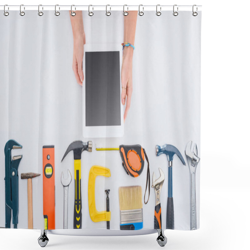 Personality  Cropped Shot Of Woman Using Tablet With Various Tools Lying On White Shower Curtains