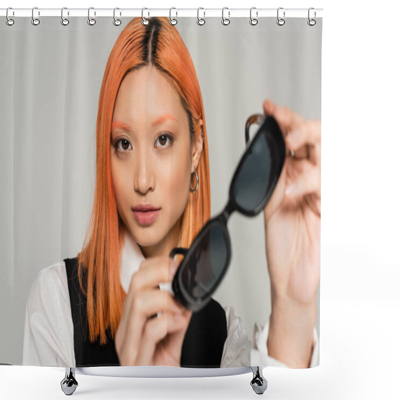 Personality  Portrait Of Appealing And Trendy Asian Woman In White Shirt And Black Vest, With Dyed Red Hair Holding Blurred Dark Sunglasses And Looking At Camera On Grey Background, Modern Fashion Shower Curtains