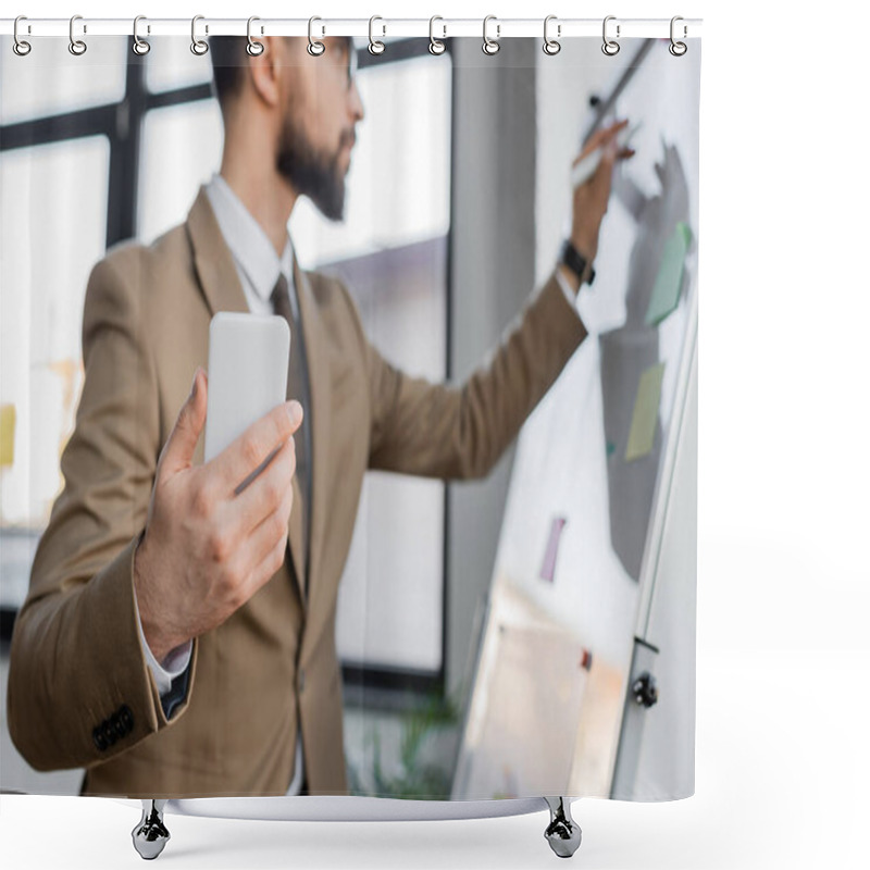 Personality  Businessman In Elegant Beige Blazer Holding Smartphone And Writing On Flip Chart With Marker While Doing Productivity Analysis In Office, Blurred Background Shower Curtains