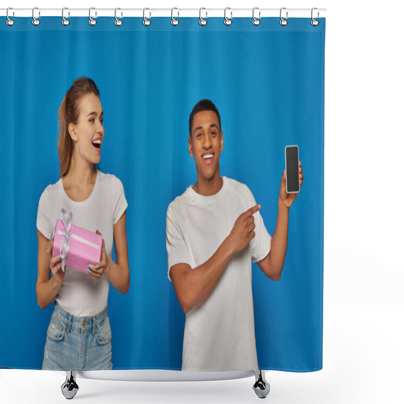 Personality  E-commerce, Happy African American Man Pointing  At Smartphone Near Woman With Gift On Blue Backdrop Shower Curtains