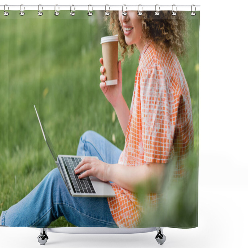 Personality  Cropped View Of Cheerful Freelancer With Curly Hair Holding Paper Cup And Using Laptop While Sitting On Grass  Shower Curtains