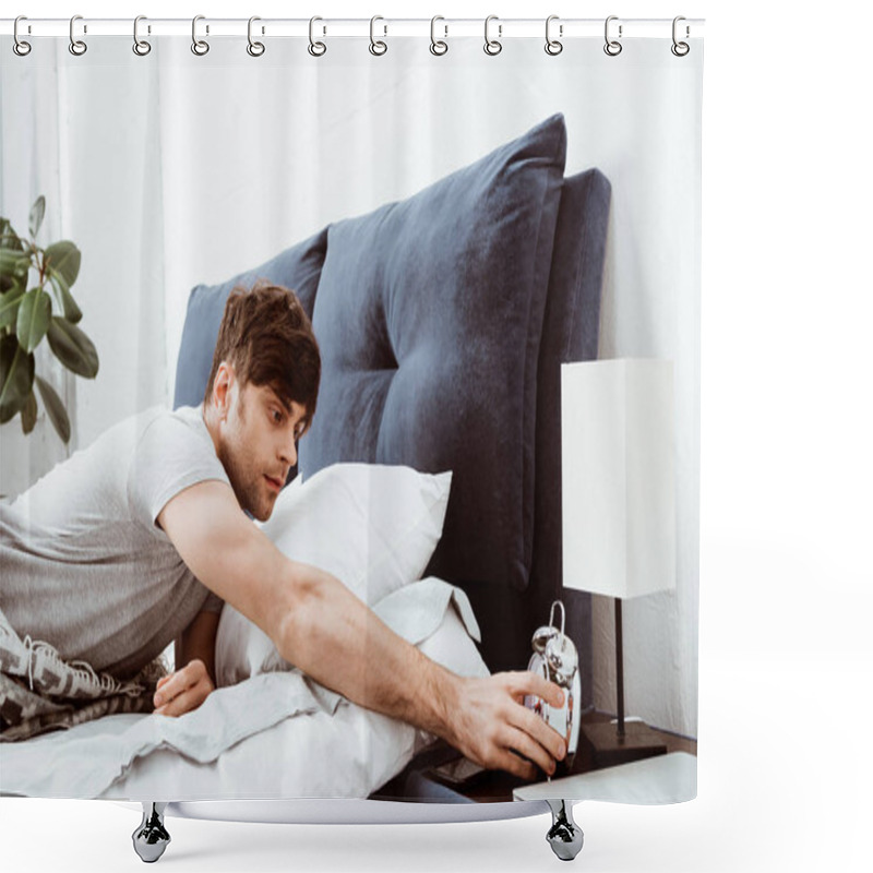 Personality  Selective Focus Of Young Man Turning Off Alarm Clock In Bed At Home Shower Curtains