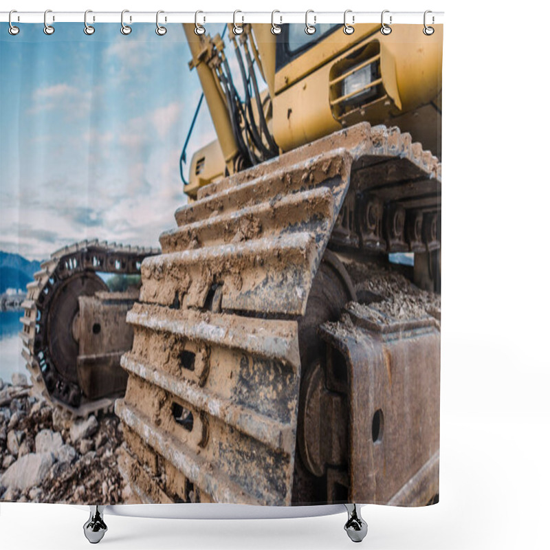 Personality  Mud-Covered Excavator Tracks On A Rocky Construction Site With A Mountain And Water Background Shower Curtains