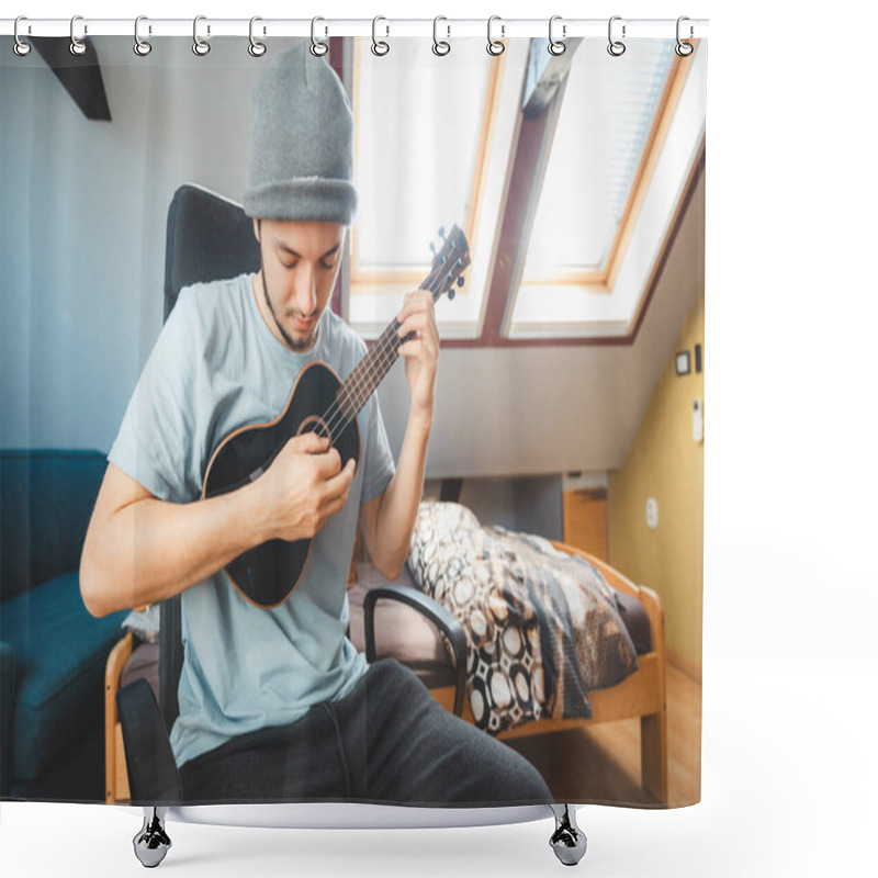 Personality  Musician Wearing A Beanie And Light Blue Shirt Plays A Black Ukulele While Seated In A Sunlit Room. Man Is Enjoying The Feeling Of Playing The Ukulele And Immersing Oneself In The Creative Life. Shower Curtains