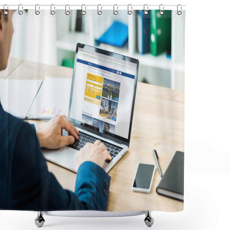 Personality  KYIV, UKRAINE - JULY 8, 2019: Man Typing On Laptop With Booking Website Near Smartphone With Blank Screen On Table  Shower Curtains