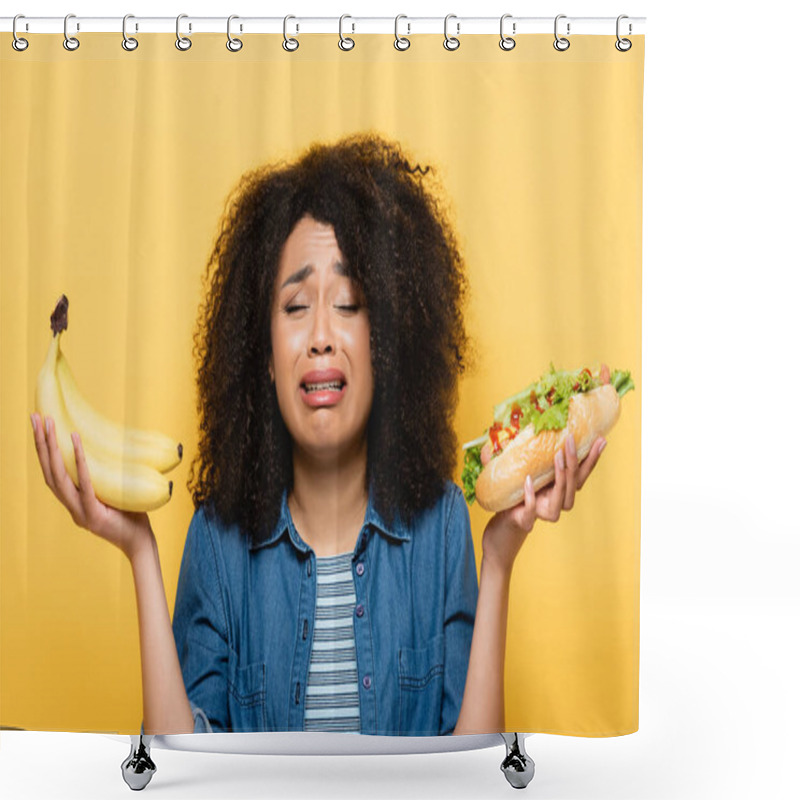 Personality  Upset African American Woman Choosing Between Fresh Bananas And Hot Dog Isolated On Yellow Shower Curtains