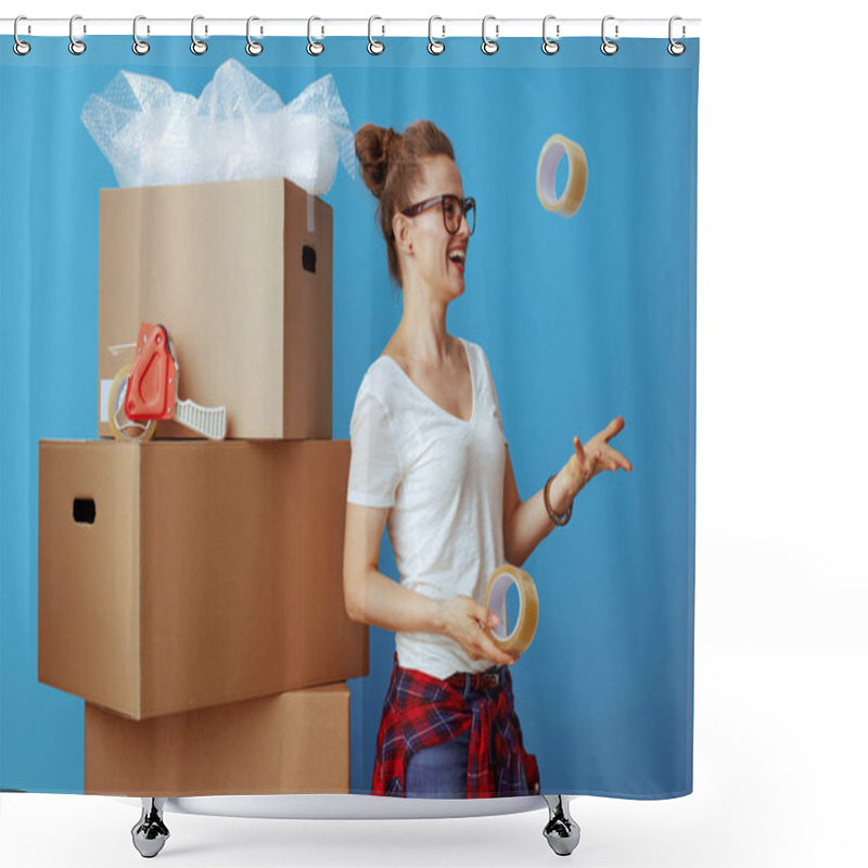 Personality  Smiling Modern Woman In White T-shirt Near Cardboard Box Throwing Up Adhesive Tapes Isolated On Blue Shower Curtains