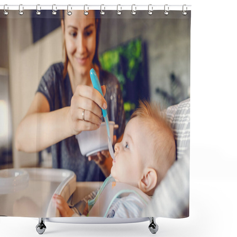 Personality  Hungry Caucasian Baby Boy With Bib Sitting In His Chair And Eating Baby Food. His Mother Giving Him Food For The First Time. Shower Curtains