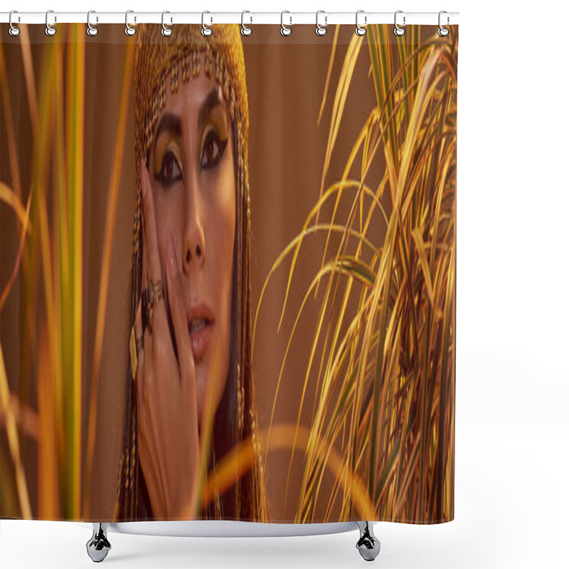 Personality  Woman In Egyptian Headdress Touching Cheek While Standing Near Plants Isolated On Brown, Banner Shower Curtains