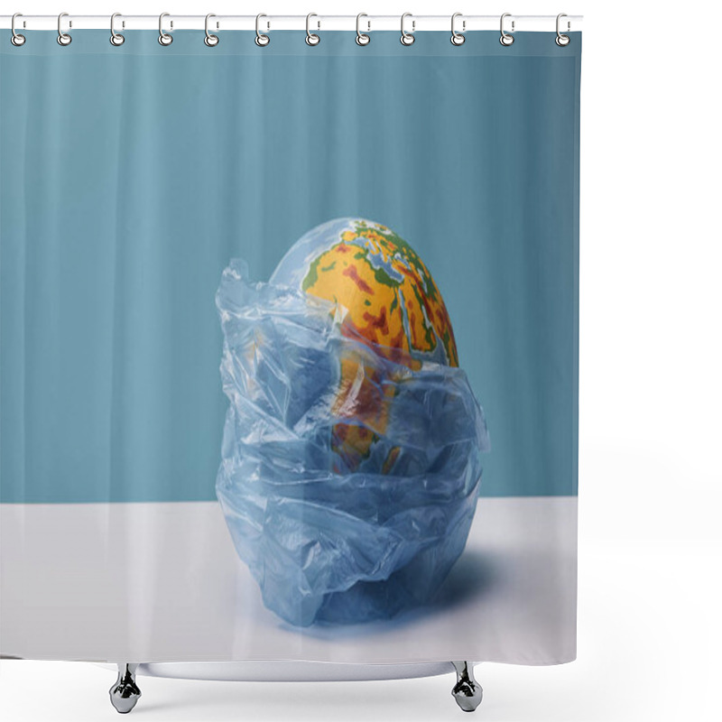 Personality  Globe In Polyethylene Bag On White Table And Blue Background Shower Curtains