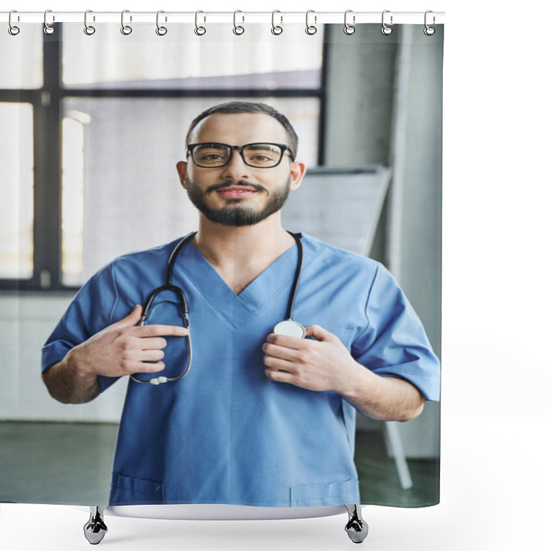 Personality  Cheerful Bearded Healthcare Worker With Radiant Smile Standing In Blue Uniform And Touching Stethoscope On Neck In Clinic, First Aid Training Seminar And Emergency Preparedness Concept Shower Curtains