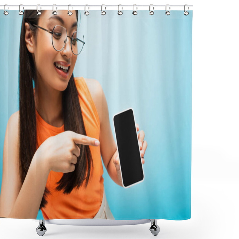 Personality  Cheerful Asian Girl In Glasses Pointing With Finger At Smartphone With Blank Screen On Blue Shower Curtains