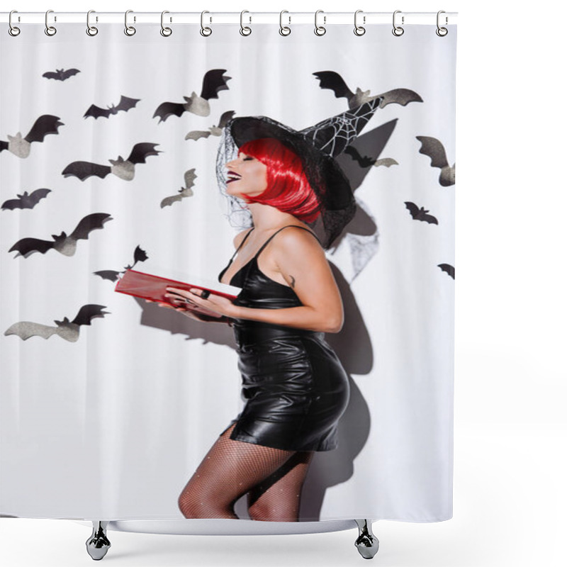 Personality  Side View Of Laughing Girl In Black Witch Halloween Costume With Red Hair Holding Book Near White Wall With Decorative Bats Shower Curtains