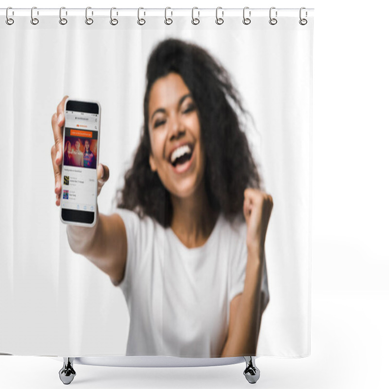 Personality  KYIV, UKRAINE - MAY 29, 2019: Selective Focus Of Happy American Girl Holding Smartphone With Soundcloud App On Screen And Gesturing Isolated On White  Shower Curtains