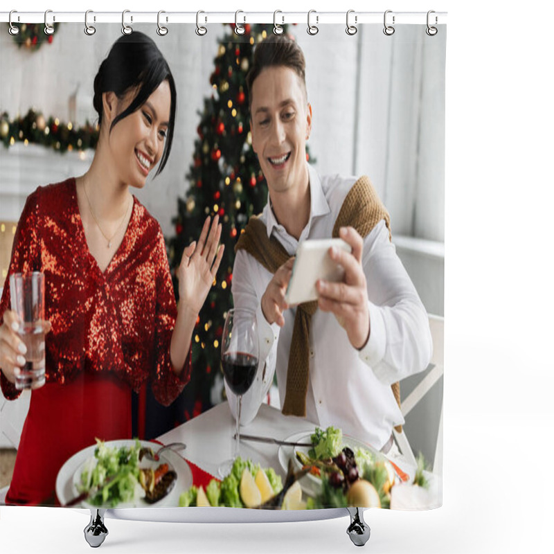 Personality  Smiling Man Holding Smartphone Near Pregnant Asian Wife Waving Hand During Video Call During Festive Supper Shower Curtains