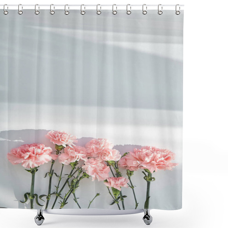 Personality  Top View Of Pink Carnations On White Background With Sunlight And Shadows Shower Curtains