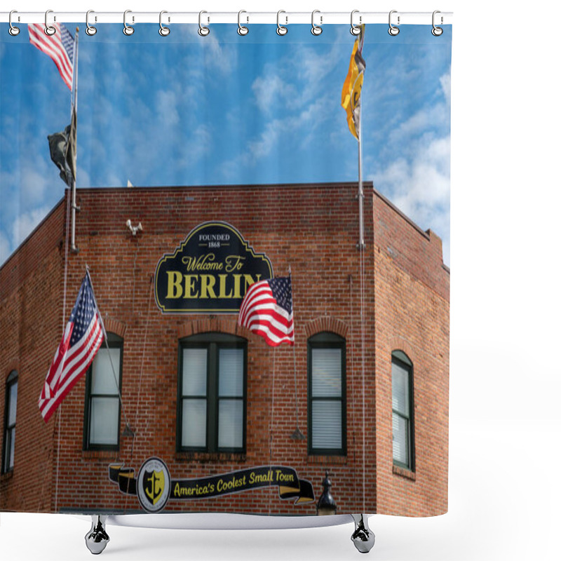 Personality  Berlin, Maryland, USA Sept 4, 2024 The Red Brick Facade Of A Landmark Building With Flags And Sign: America's Coolest Small Town.  Shower Curtains