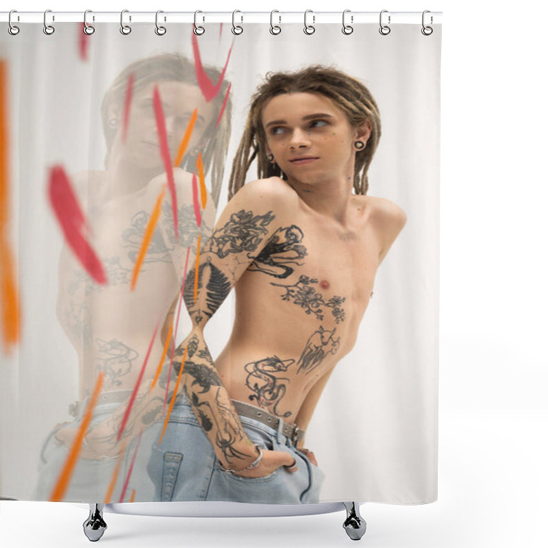 Personality  Young Tattooed Nonbinary Model Standing With Hands In Pockets Of Jeans Near Glass With Paint Strokes On White Background Shower Curtains