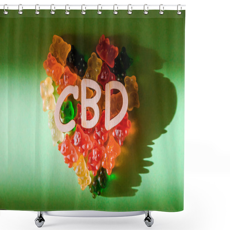 Personality  Photo Of Wooden Letters CBD On A Green Background And Bears Gelatin In The Form Of Heart. View From Above. The Shadow Of The Sun Falls On The Background. Top View Shower Curtains